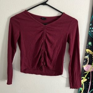 I am selling a 10-12 maroon v-neck with a tie string